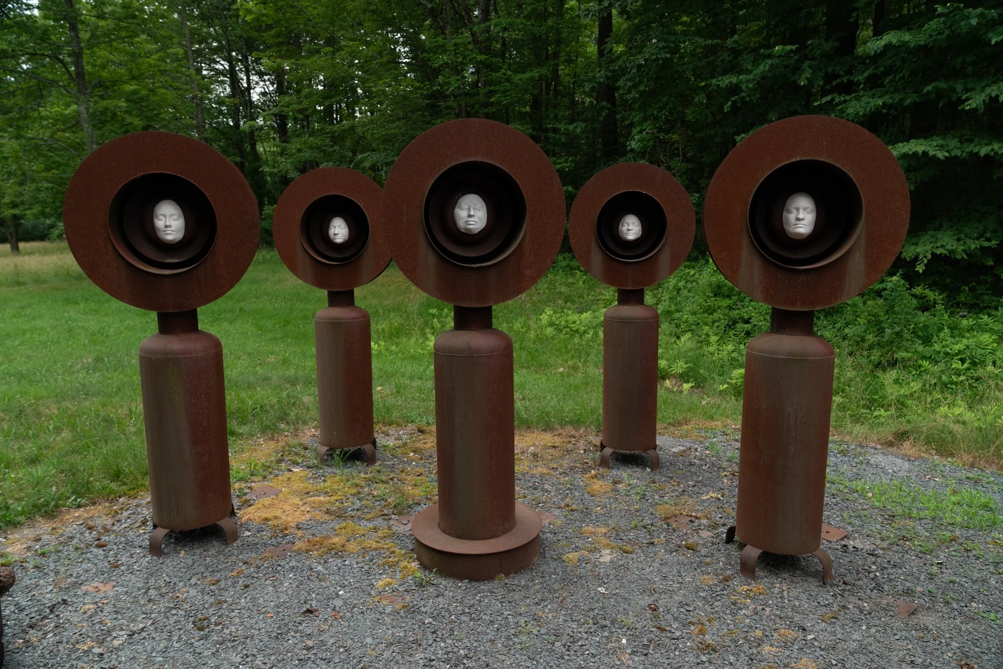 Monuments - Sculptures  serving  as a lasting reminder of former students in my Advanced Sculpture class.. Welded steel, cast clay faces. Overall 20” x 8’ x 8’. 2010