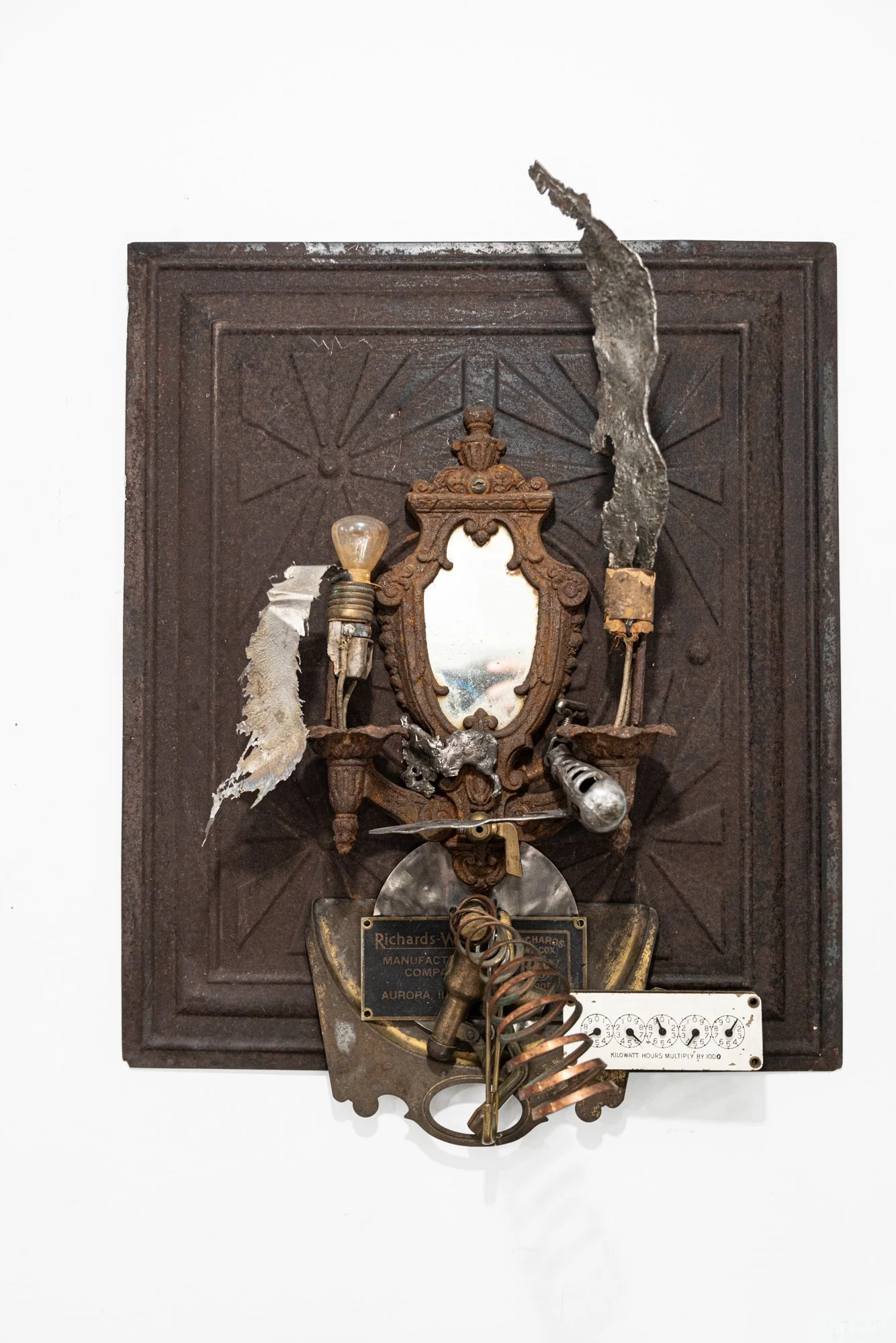 Thermal Evidence - Inspired by those objects that generate energy. Vintage tin panel, light with mirror, cast stainless steel, machine parts, copper, brass, energy use gauge. 28” x 15.5” x 12”. 2019.