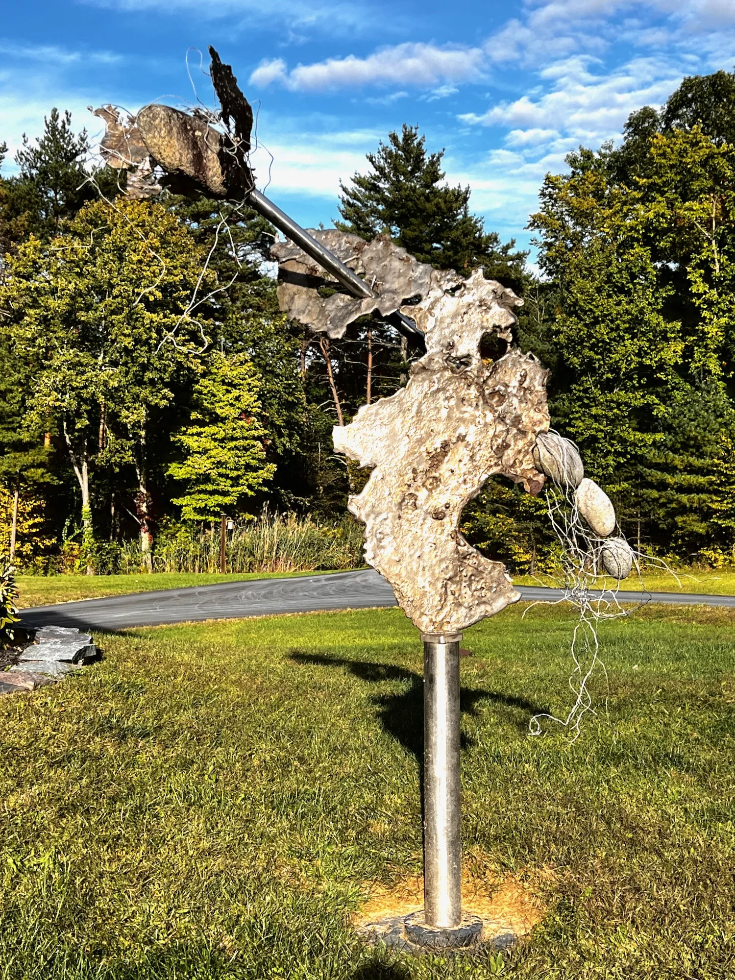 Surge - Inspired by emulating a dramatic forward and upward movement. Cast stainless steel, stainless pipe, stones, aluminum wire. 11’8” x 8’ x 2’. 2008