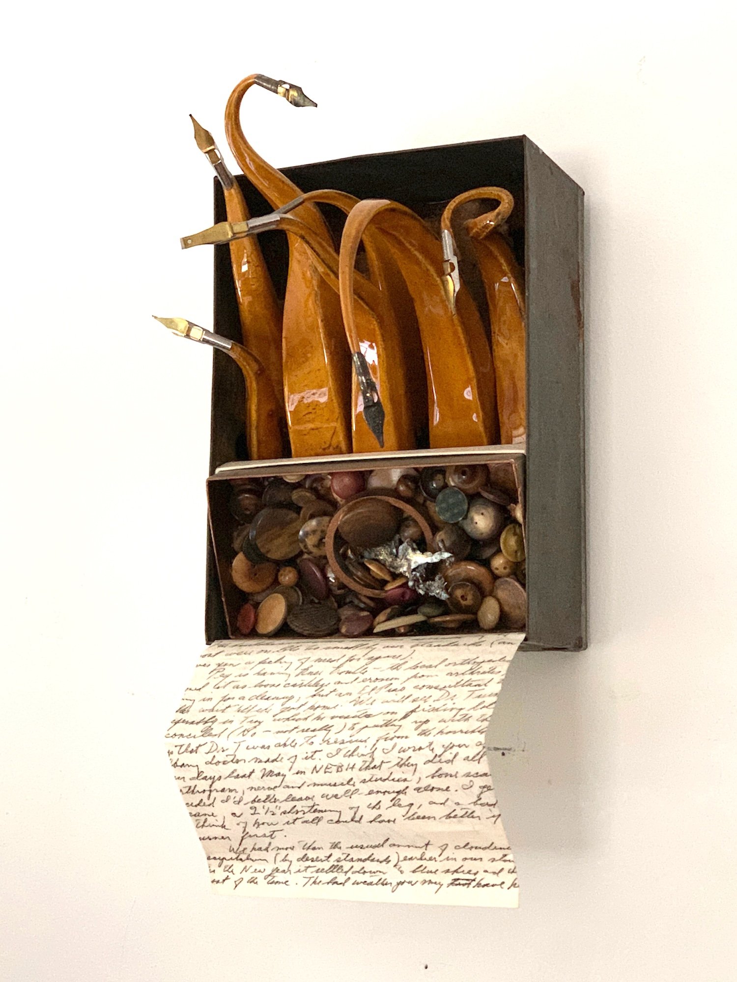 Scripted - Inspired by cursive writing. Vintage metal box, clay, letter written in cursive, buttons, bronze, steel, pen nibs. 12” x 16” x 7.5” 2010