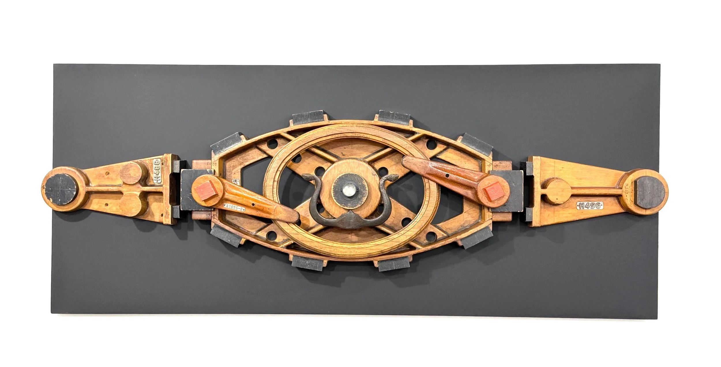 Bove - Commissioned by the Boves. Inspired by equality in relationships. Wood pattern pieces, oak frame, vintage metal, glass gem. 20’ x 48 ¾” x 6.5” 2025 (in a private collection)