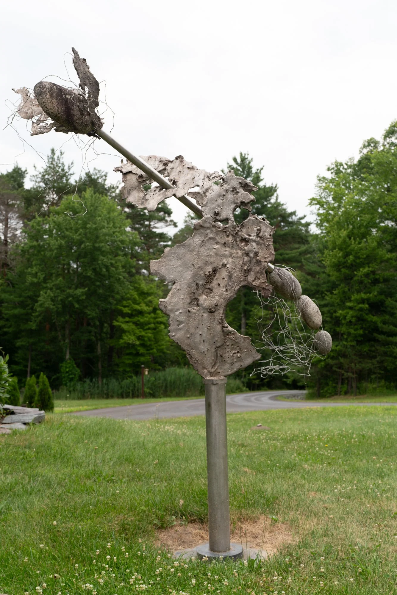 Surge - Inspired by emulating a dramatic forward and upward movement. Cast stainless steel, stainless pipe, stones, aluminum wire. 11’8” x 8’ x 2’. 2008