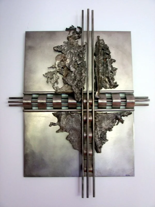 Crosscut - Inspired by the idea of going against the grain. Cast and welded stainless steel. 21” x 24” x 6”. 1989