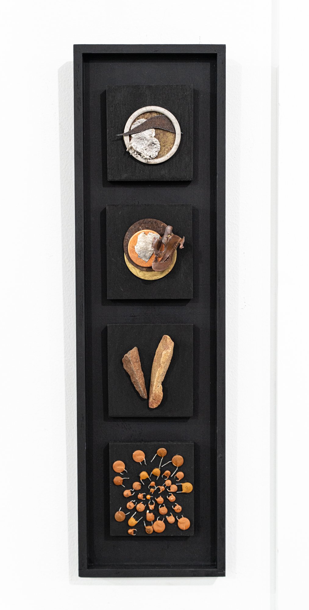 Four Parts -  This piece illustrates the transformation from a cohesive, solid shape to a fragmented arrangement of elements. Wood, stone, copper, brass, electrical components, stainless steel ring, steel, mica. 
16” x 6” x 1.5”.  2014
