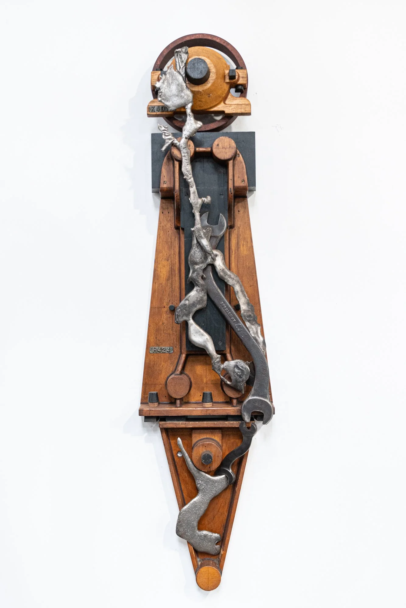 Crossover - Inspired by the idea of transition or shifting from one form to another. Wood pattern pieces, curved wrench, cast stainless steel. 48  ‘ x 12.5” x 6”. 2022