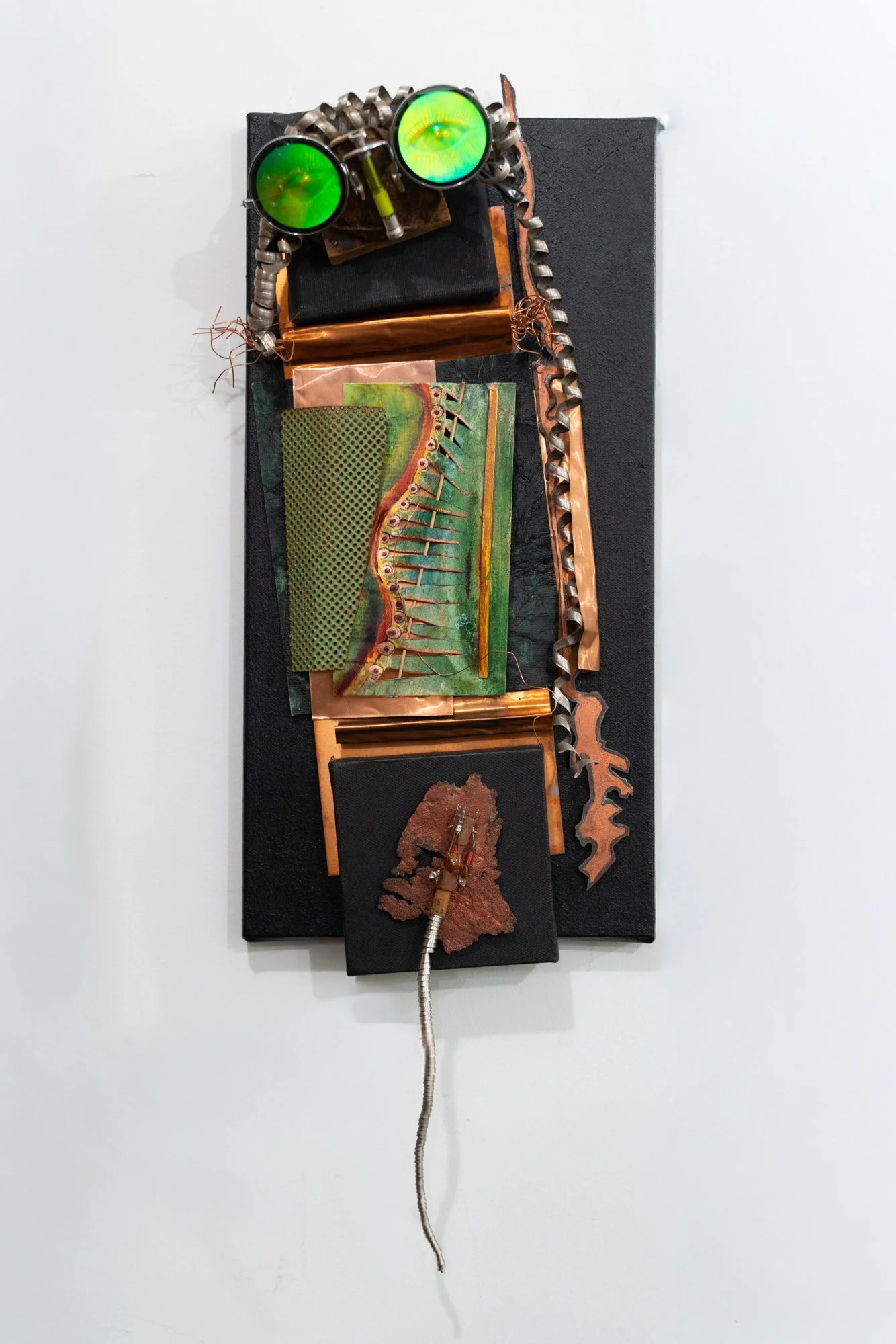 Crazed - The design of this piece is derived from glasses that possess a frantic or agitated appearance. Stainless steel coils, rusty steel, copper, cardboard, paint, commercial glasses. 20” x 8” x 3”. 2021