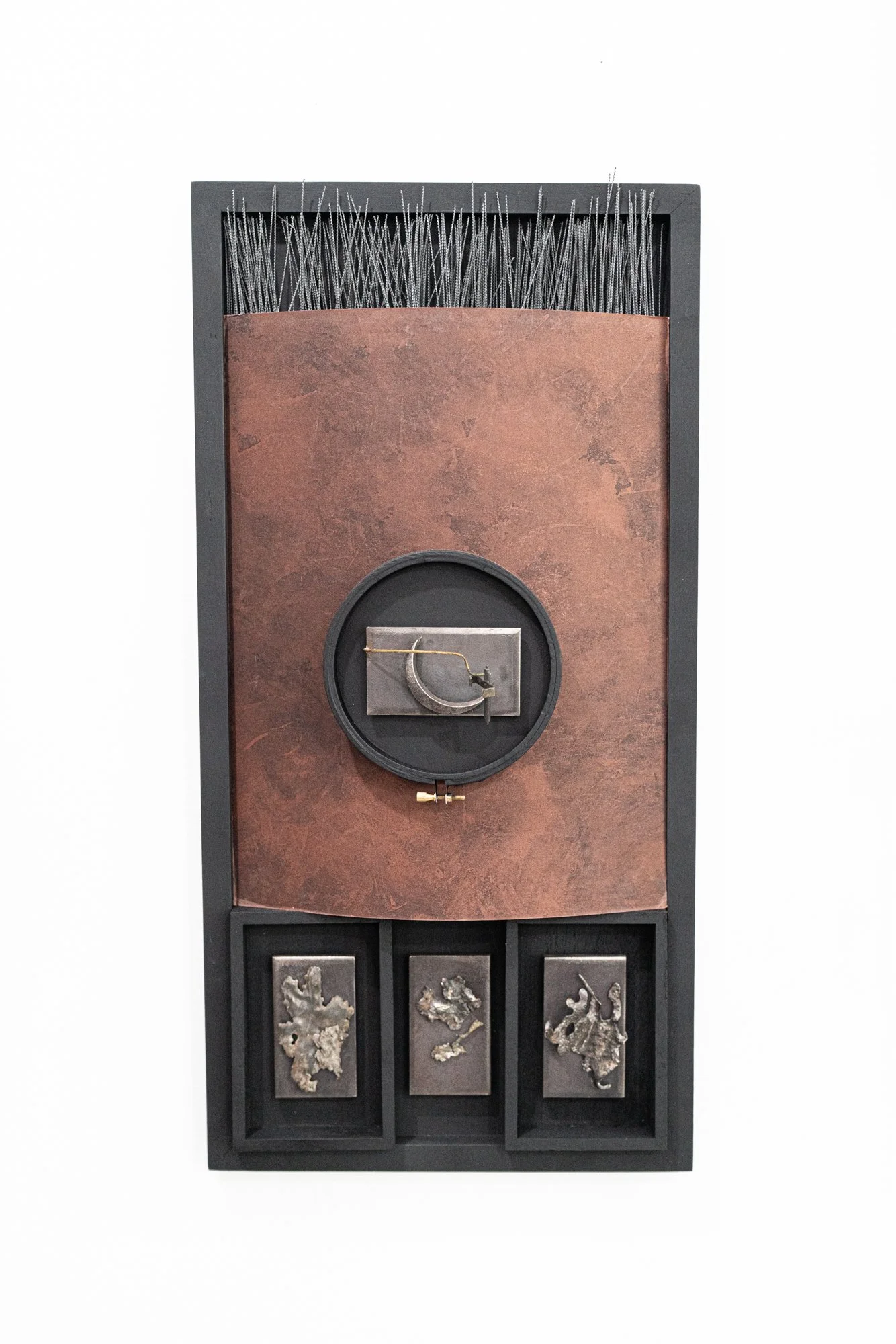 Seeking Solitude - Concept of looking for peace and quiet. Wood, metal, cast stainless steel, matt board, needle point frame. 24” x 12” x 5.75”. 2024