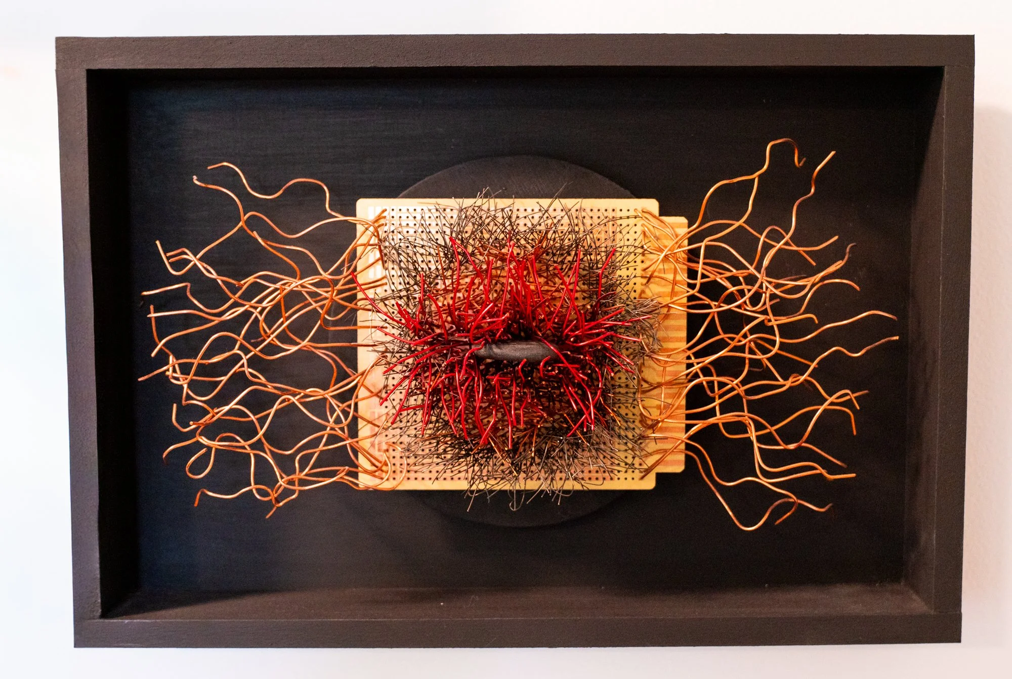 Deep Within - A meditative state of looking inward. Wood frame, copper wire, red wire, circuit board, black stone. 8” x 12” x 2.5”  2022