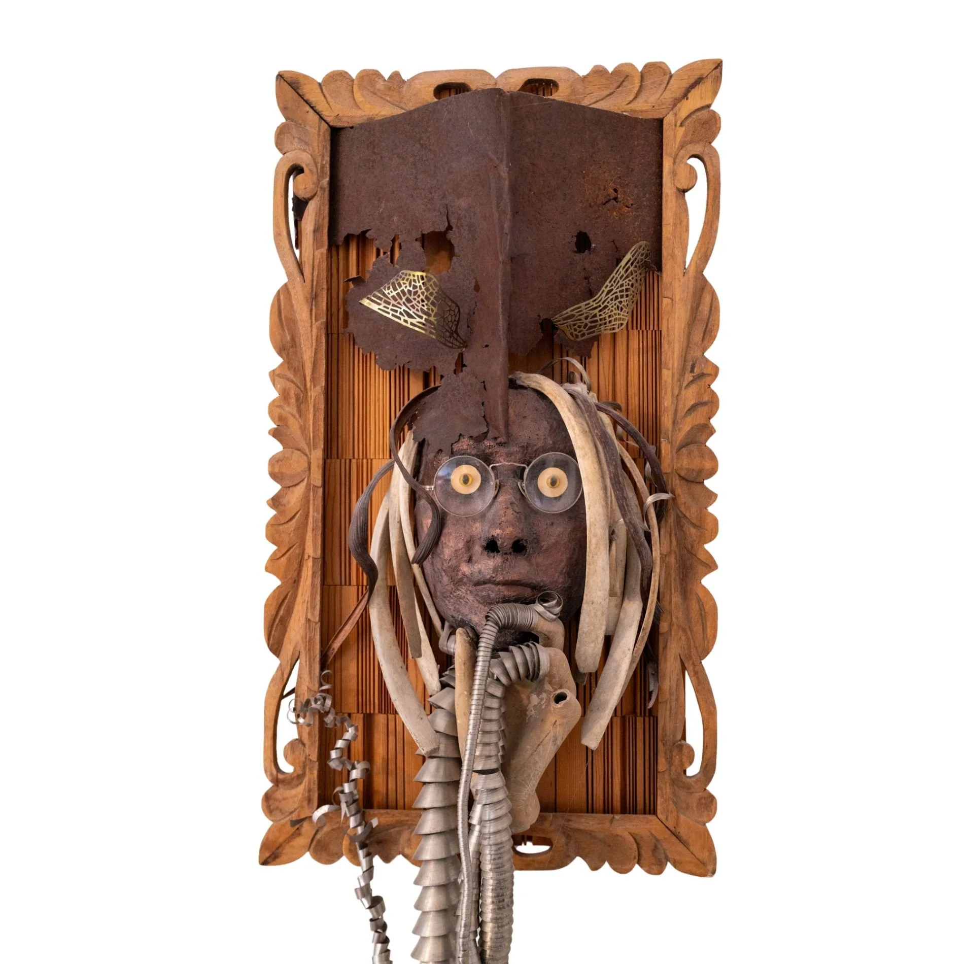 Displaced Person - Self portrait depicting a time of intense ankle pain where I attempted to “Abandon the body - rescue the brain”. Cast self portrait mask, stainless steel coils, wood spikes, drift wood, vintage wood barrel, manikin form, steel toe 