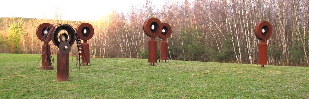 Monuments - Sculptures  serving  as a lasting reminder of former students in my Advanced Sculpture class.. Welded steel, cast clay faces. Overall 20” x 8’ x 8’. 2010
