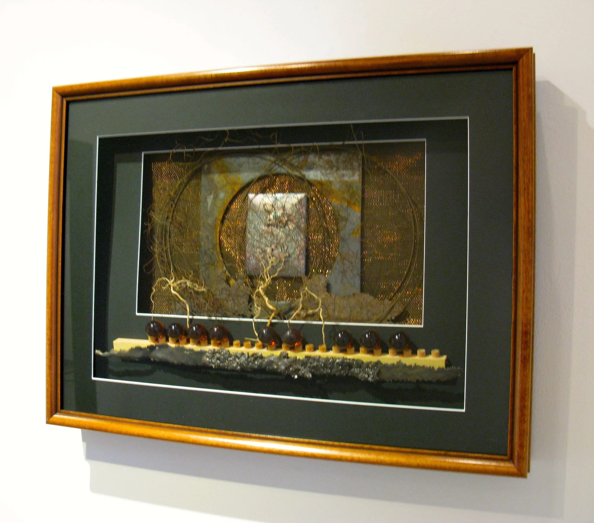 On the Edge - Inspired by the concept of being extremely tense, nervous or on the brink of discovering something new. Framed and matted, rusty steel, copper, stainless plate,roots, wood, cast stainless, glass marbles. 17” x 23” x3” 1994. (in a privat