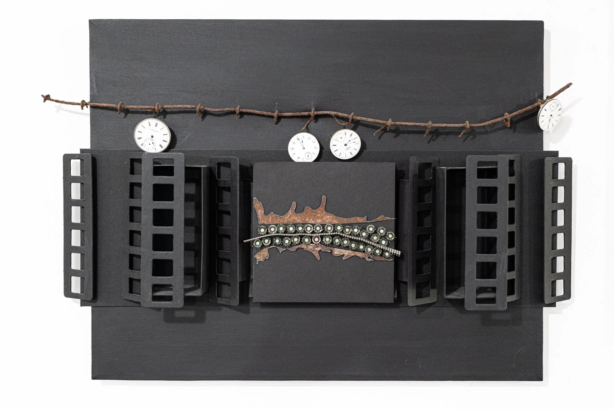 Timeline - Concept exploring the element of time. This piece is from the covid series. Canvass, barbed wire, watch faces, plasma cut steel, stainless wire and electrical components, cardboard. 16” x 23” x 3”. 2020