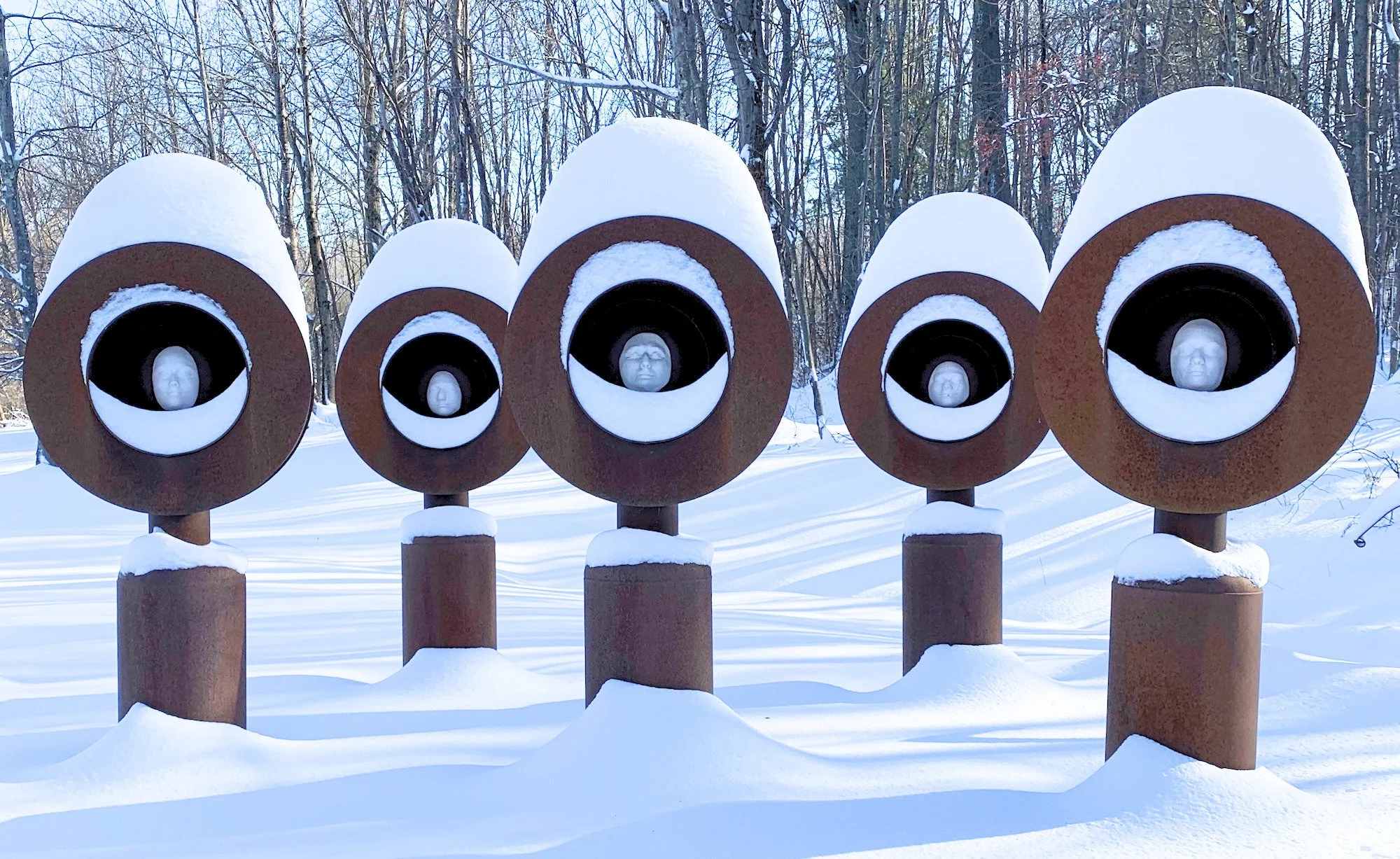 Monuments - Sculptures  serving  as a lasting reminder of former students in my Advanced Sculpture class.. Welded steel, cast clay faces. Overall 20” x 8’ x 8’. 2010