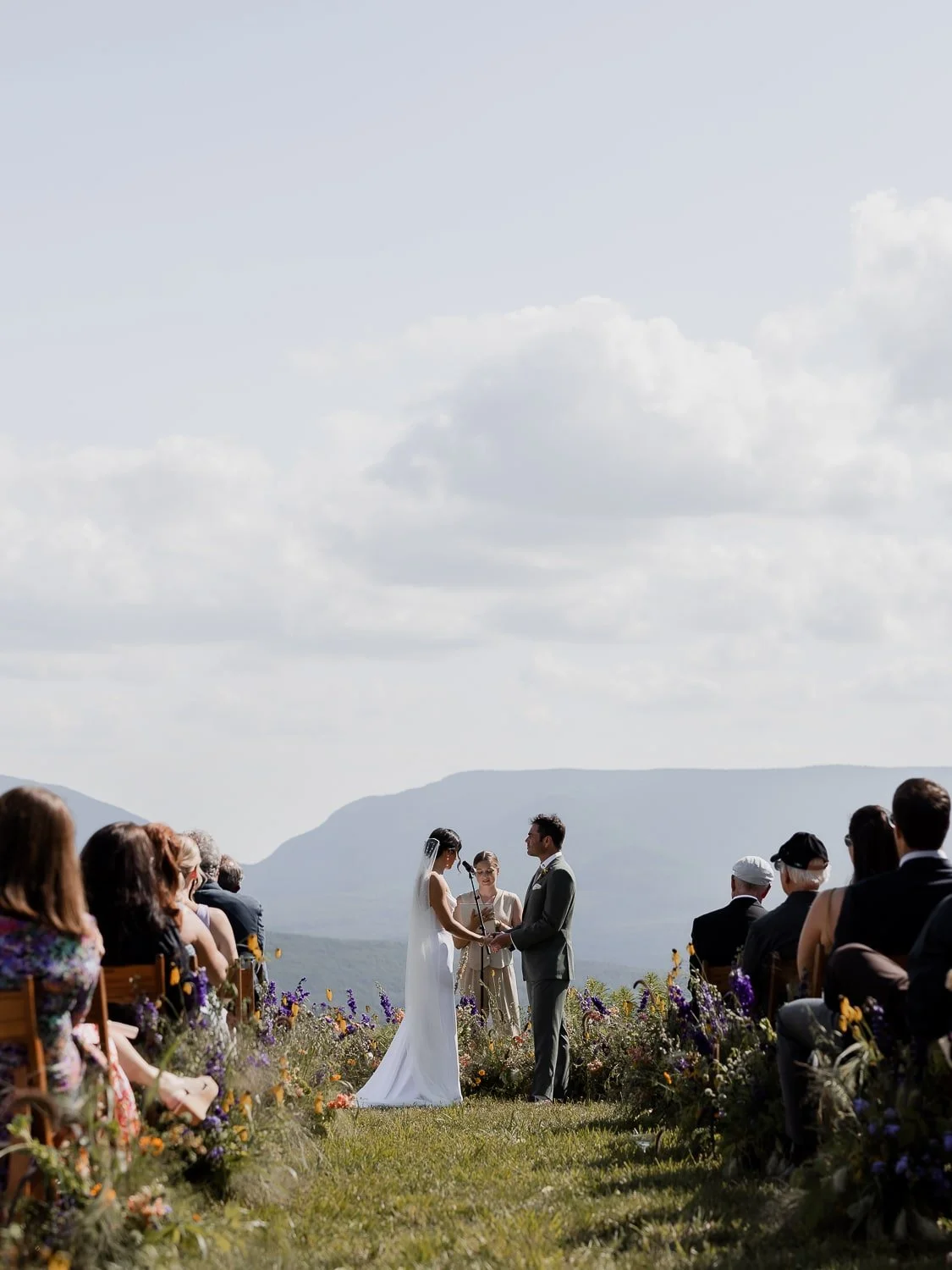 Scenic ceremony in the Catskills with a stunning mountain backdrop, blending natural beauty and refined elegance