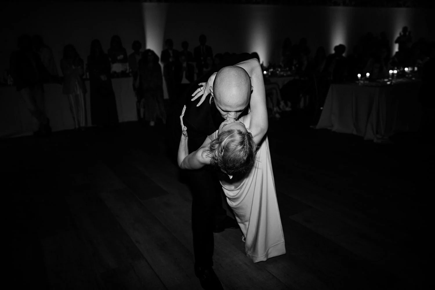 Couple sharing their first dance in the grand hall of Chateau du Clair de Lune, blending elegance and emotion