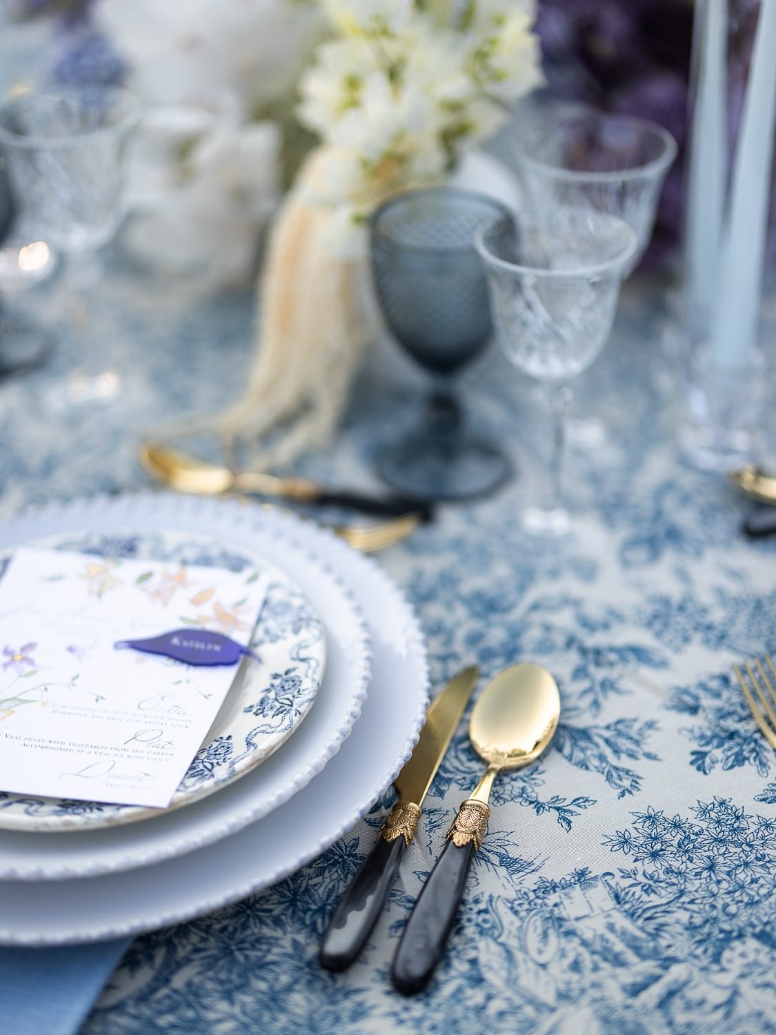 Candlelit wedding banquet setup amidst olive groves in Provence.