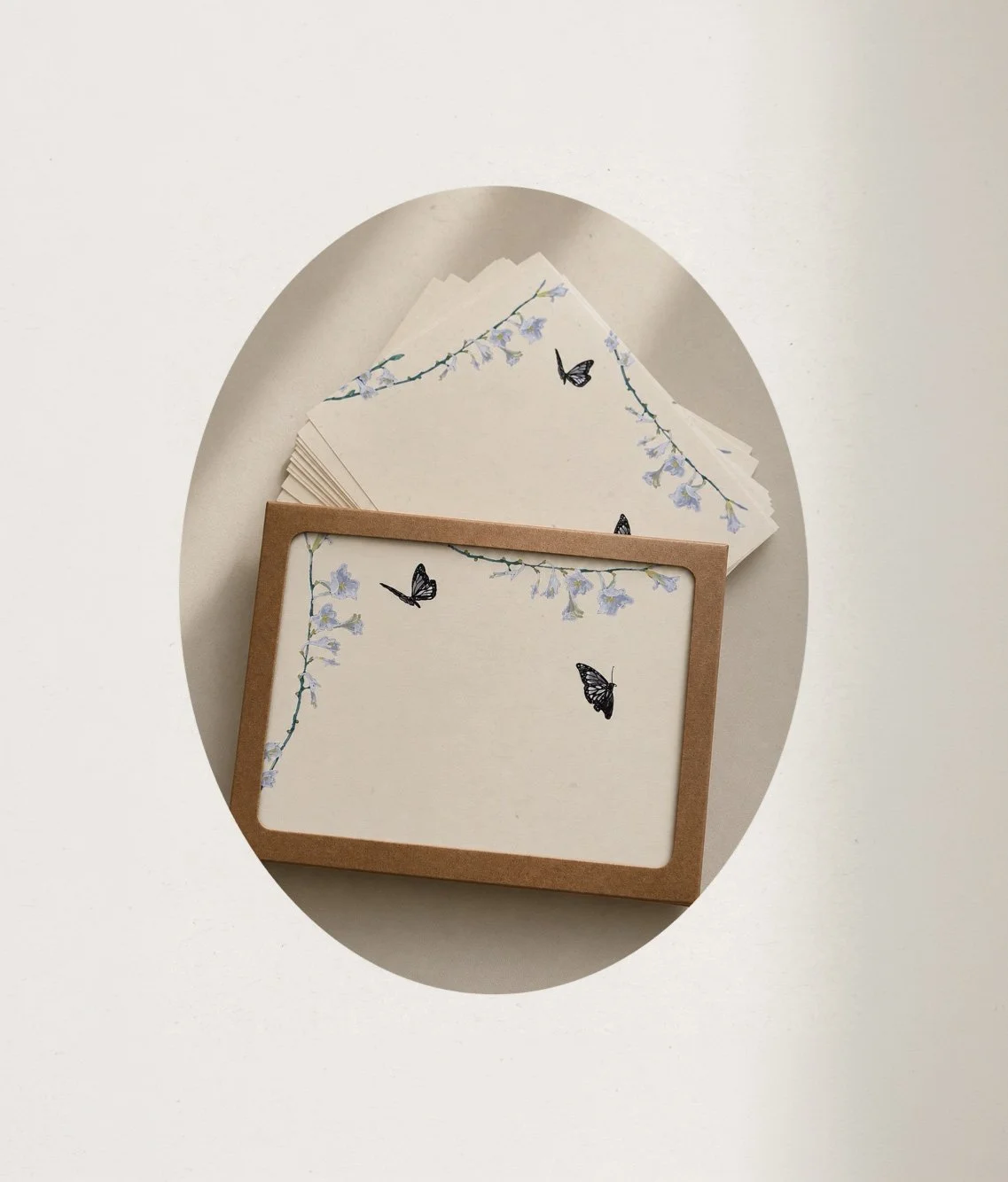 Matching stationery featuring black butterflies and light purple flowers on cream and brown backgrounds.