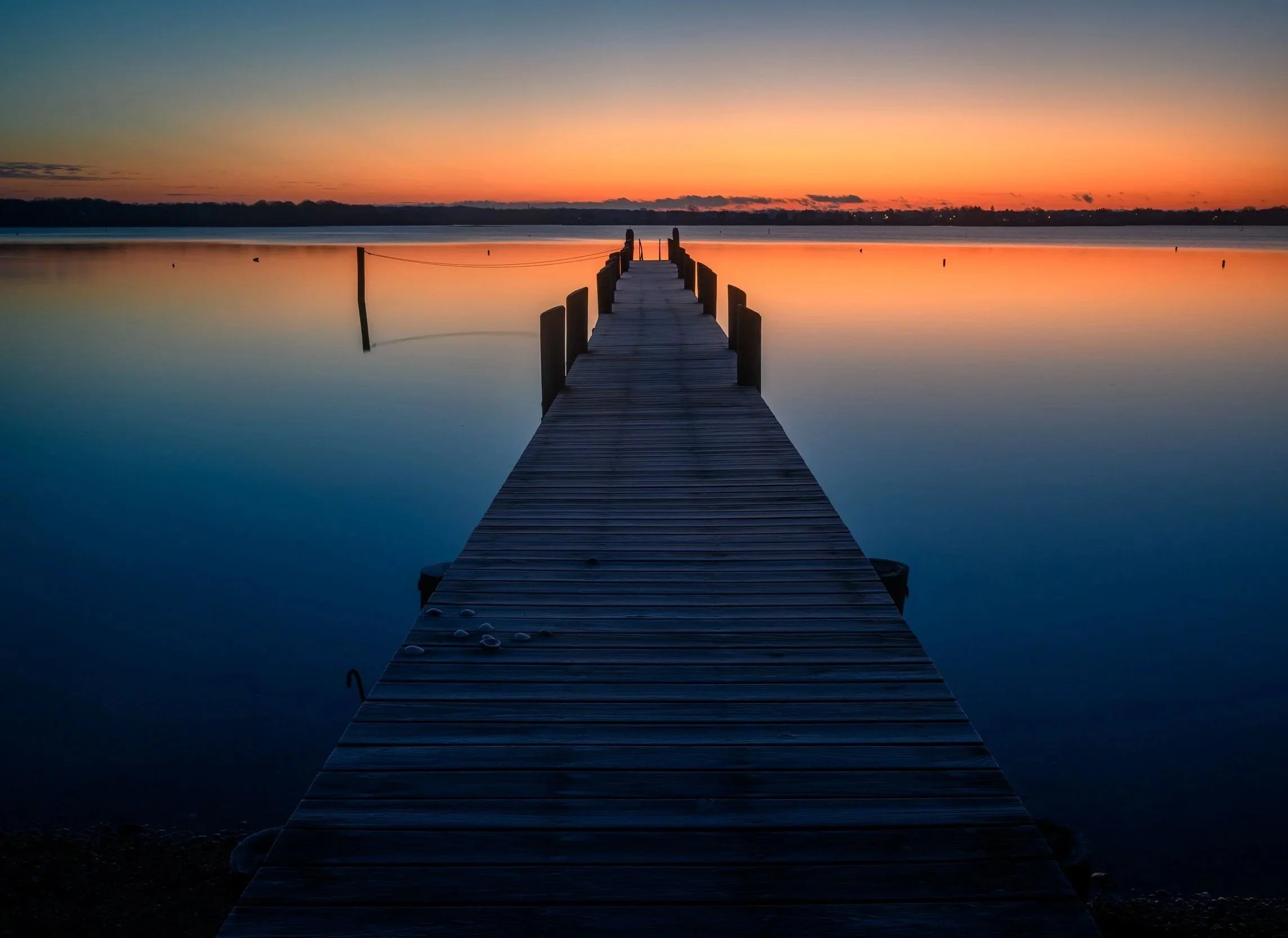 Image of a sea deck during sundown.