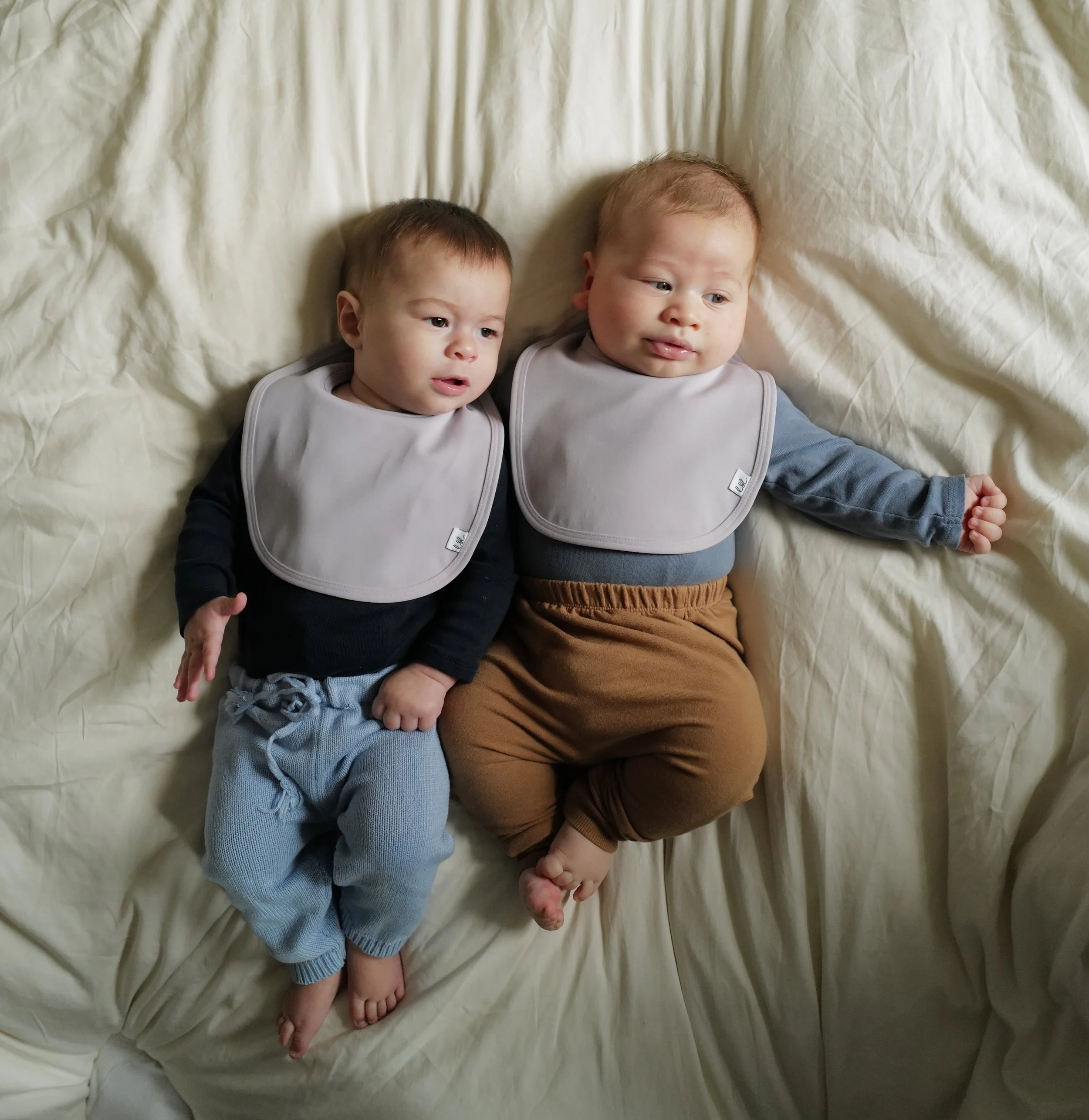 Babies wearing Leya & Lior SnapDry bib