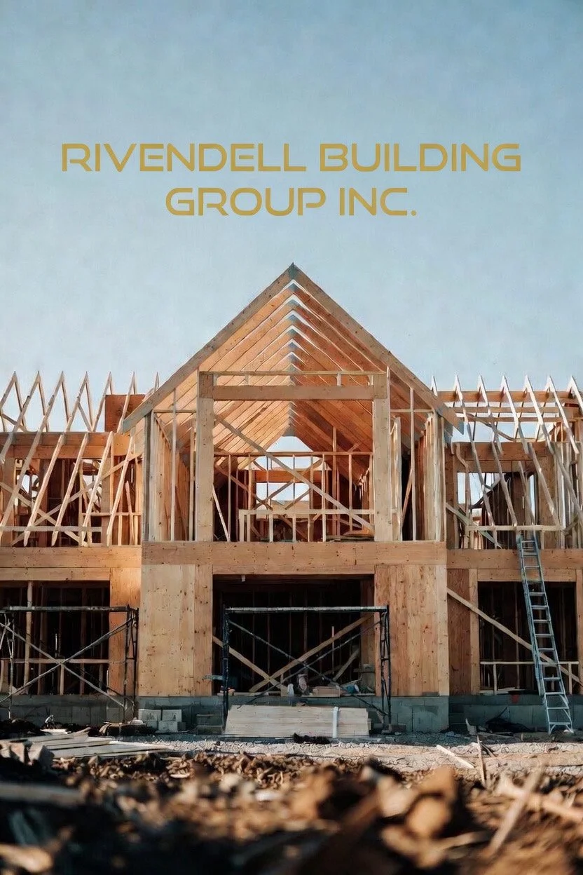 Wooden framing of a building under construction, with a peaked roof, scaffolding, and construction materials on the ground.