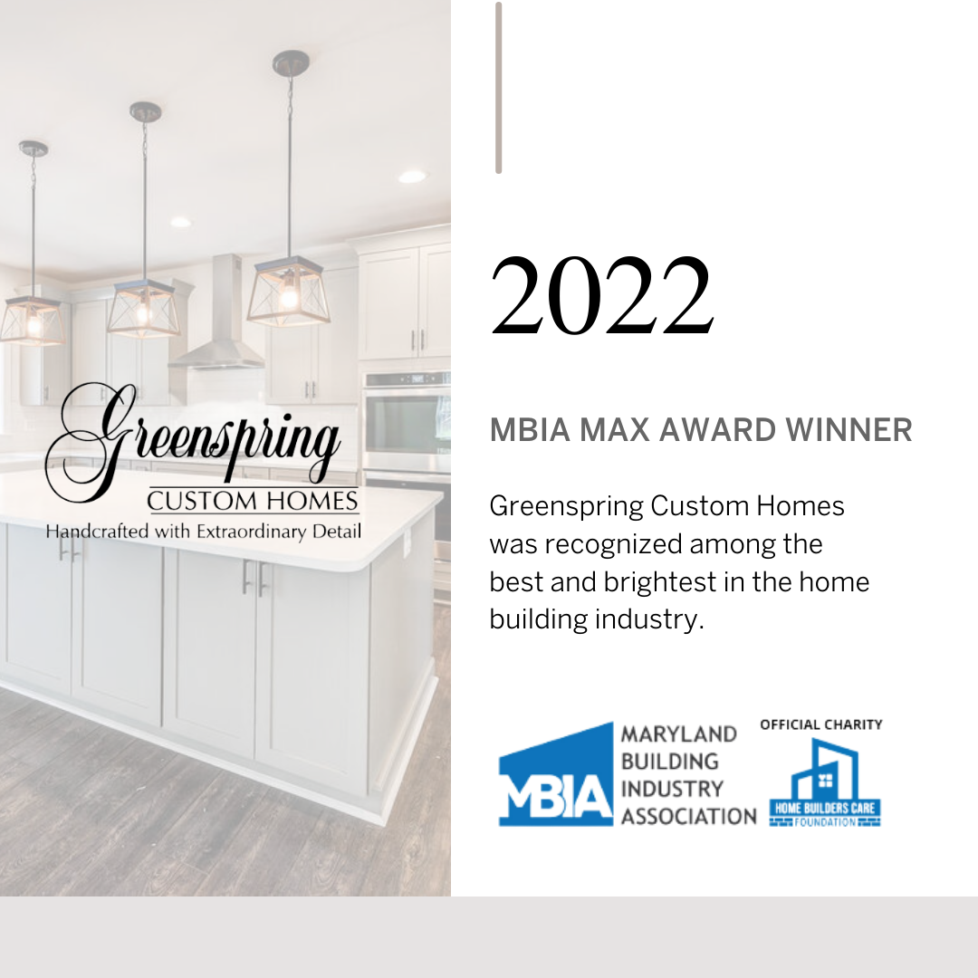 Recognition award certificate for Greenspring Custom Homes, MBIA MAX AWARD WINNER 2022, featuring a kitchen with white cabinetry, a kitchen island, pendant lights, and stainless steel appliances.