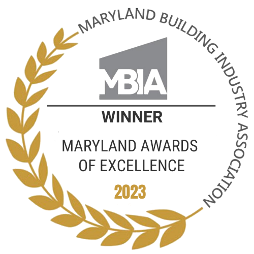Award badge for Maryland Building Industry Association 2023 winner at Maryland Awards of Excellence, with a gold laurel wreath on the left side and a gray building graphic at the top.