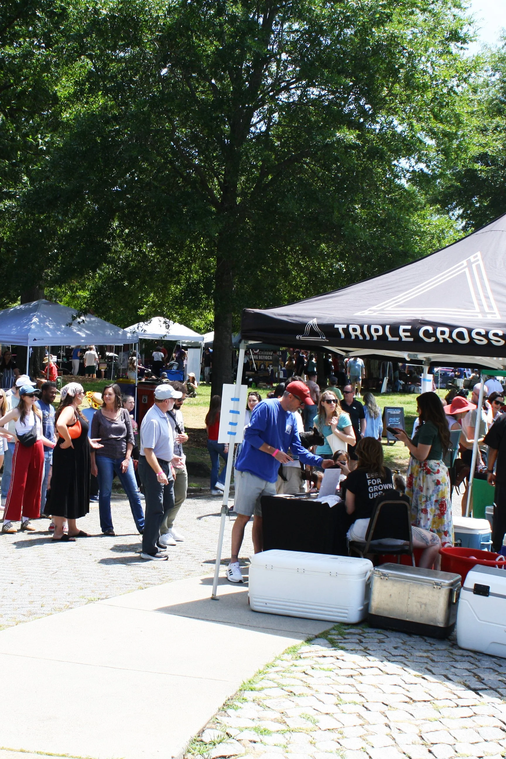 Attendees lining up at Spring Fest to buy a beer at the tent local of local brewery Triple Crossing