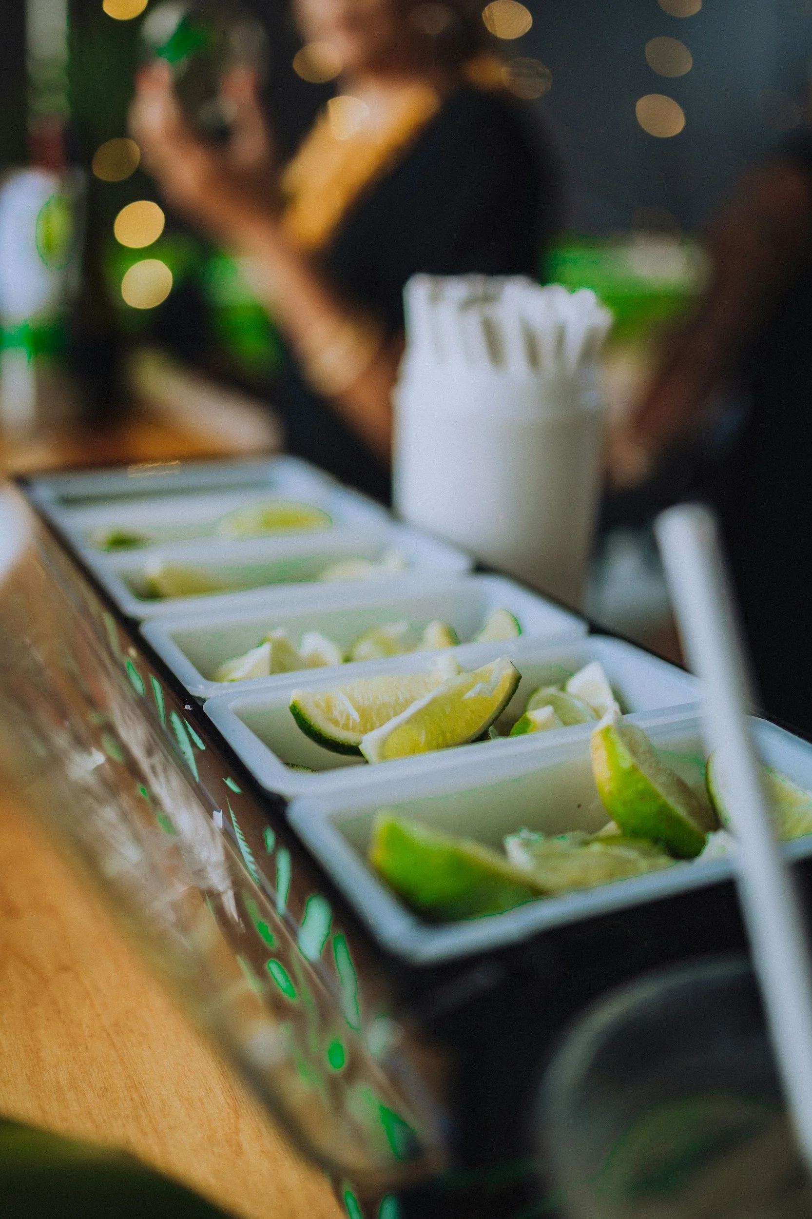 Close-up of lime and lemon wedges in a condiment station at a restaurant.