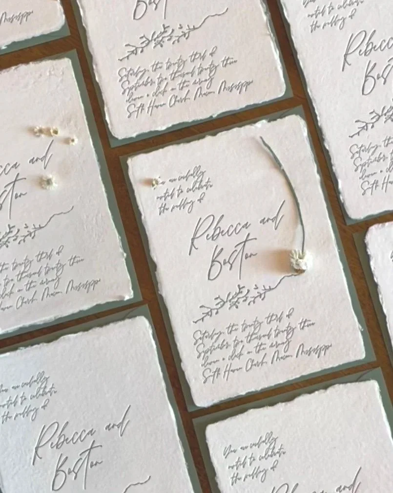 Multiple handwritten wedding invitations with torn edges, featuring names Rebecca and Ben Tan in elegant script, decorated with small floral illustrations.