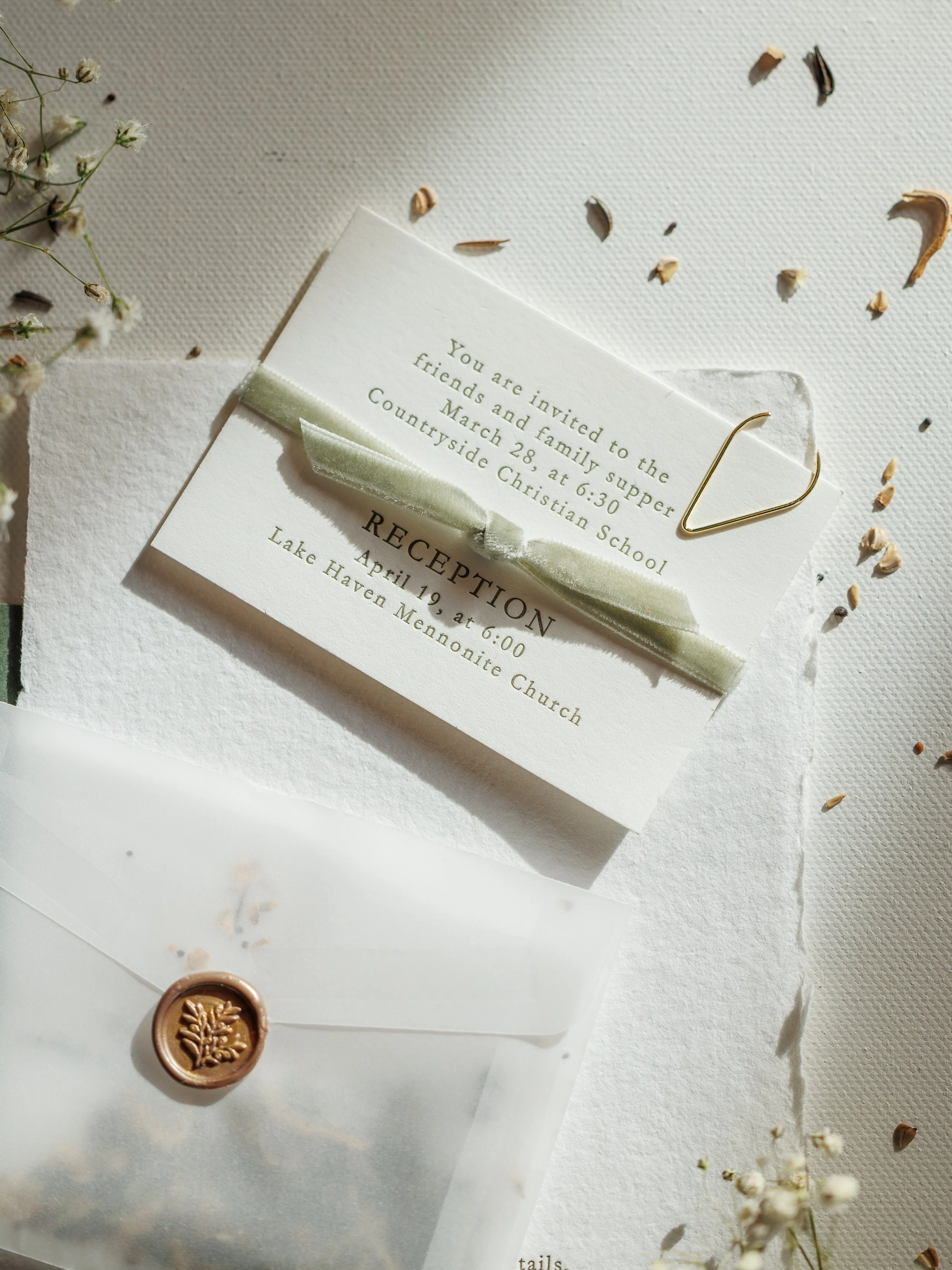Invitation to friends and family for a bridal shower on March 28th at 6:30 PM at Countryside Christian School, with a white ribbon decoration and a wax seal in the shape of a leaf.