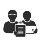 Two people working together with a document and a laptop