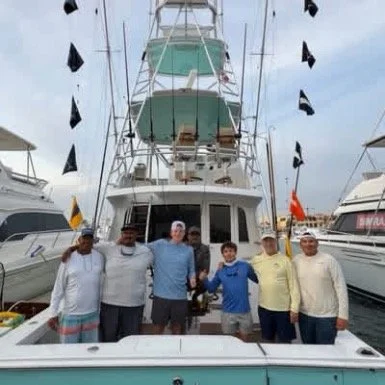 Group of fisherman showing off their marlin release flags after a successful day fishing in Cabo San Lucas