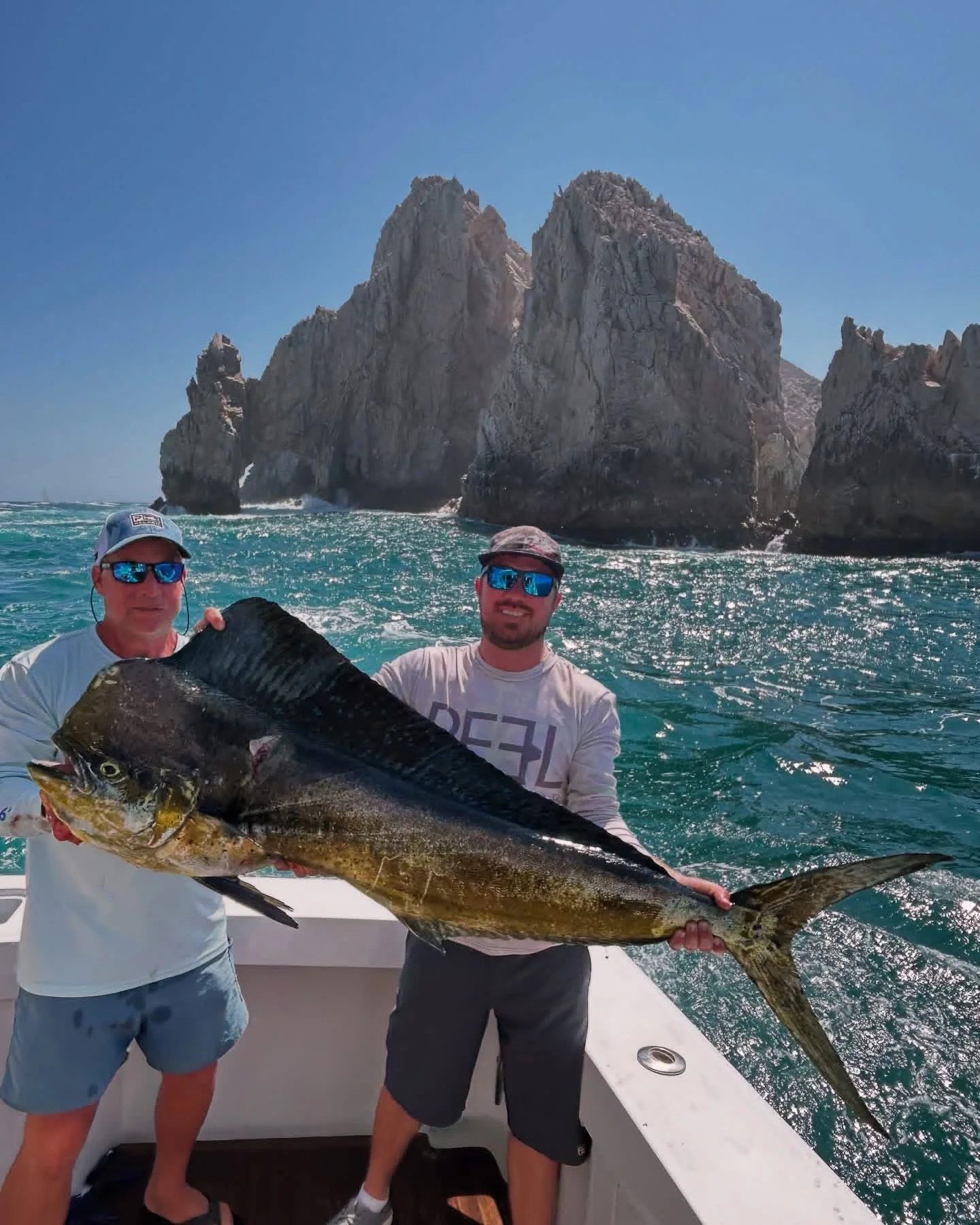 Dorado caught offshore with a view of the famous Cabo arch