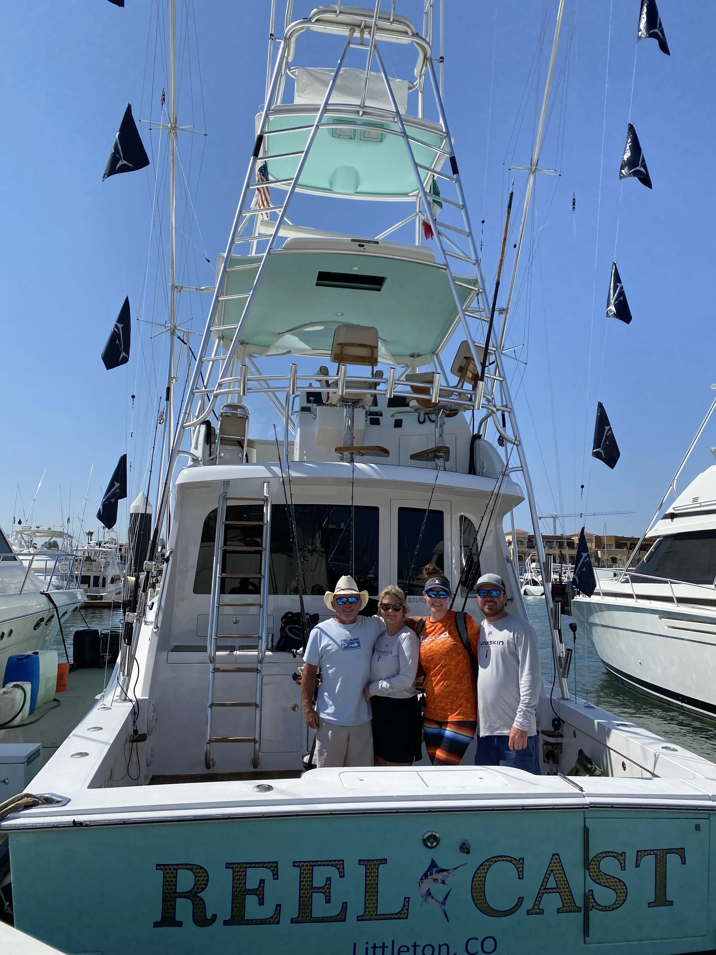 Happy family of fisherman after a successful day deep sea fishing on the Reel Cast in Cabo San Lucas