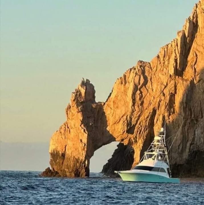 Deep sea fishing boat Reel Cast in front of the Cabo San Lucas arch