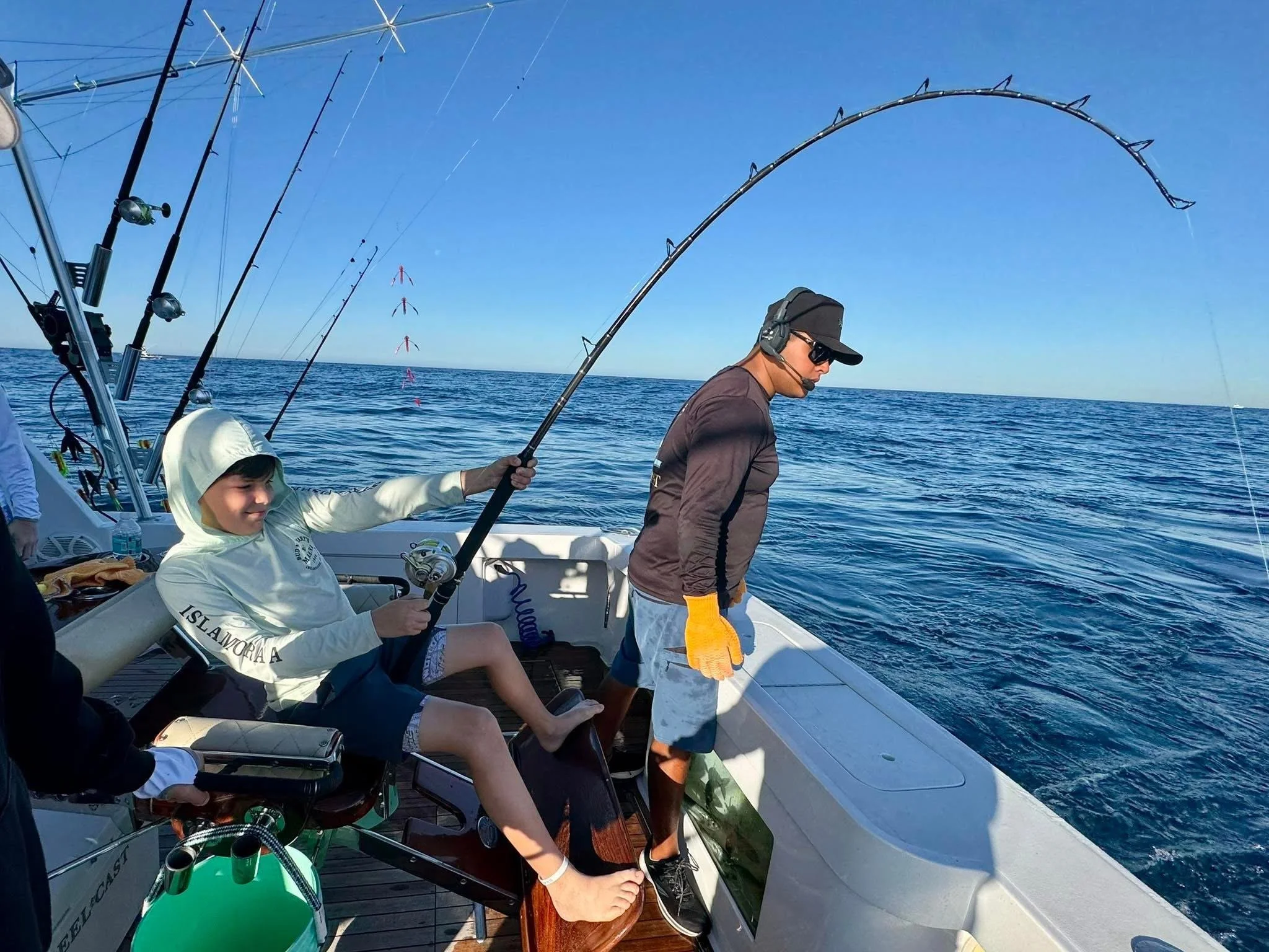 Young fisherman fights a marlin while offshore fishing in Cabo