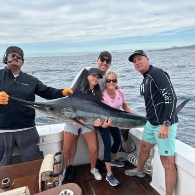 Family of anglers show of their marlin catch deep sea fishing in Cabo