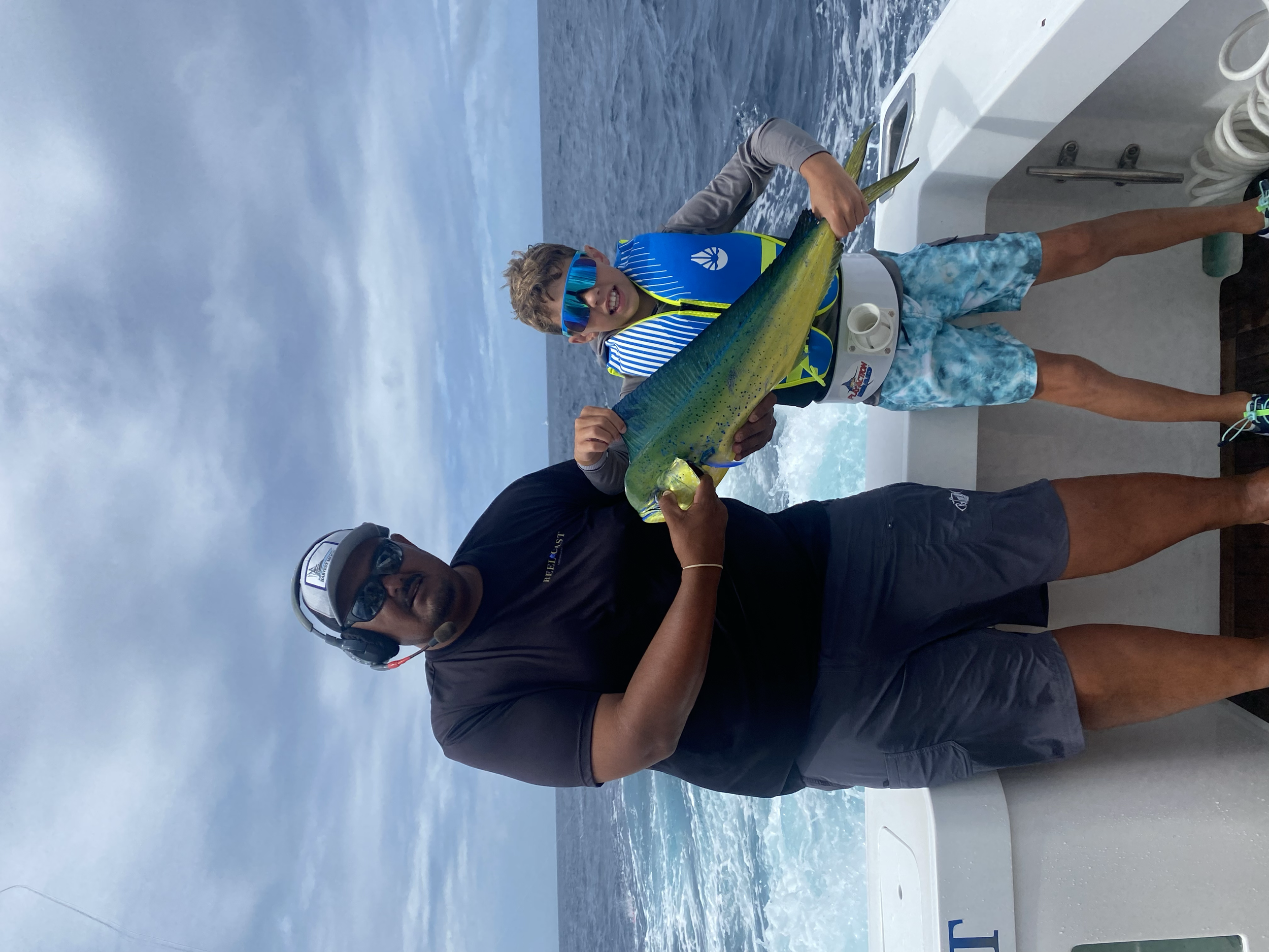 Young fisherman shows off dorado while fishing in Cabo