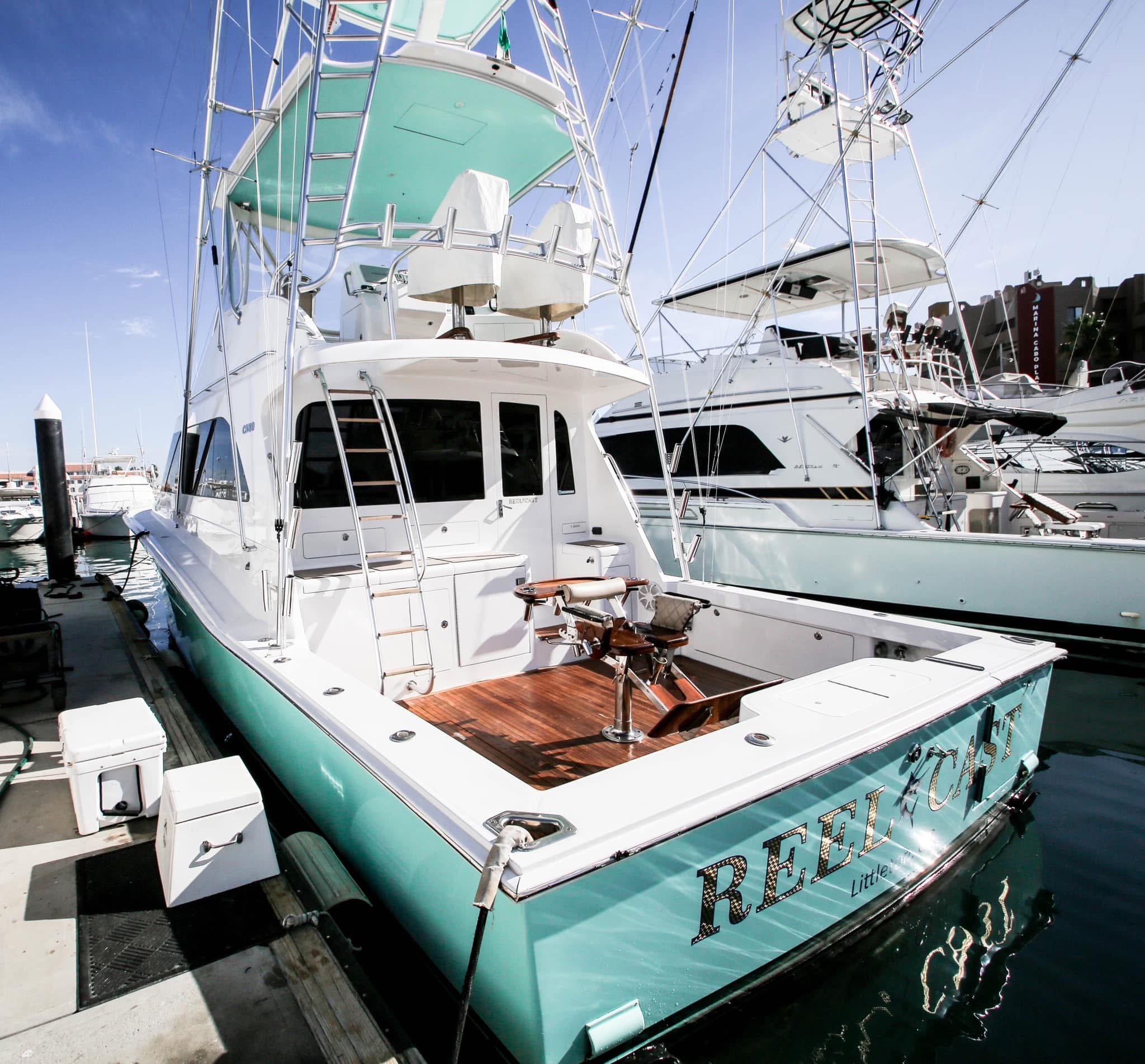 Side view of the sport fishing boat Reel Cast docked at the marina in Cabo San Lucas