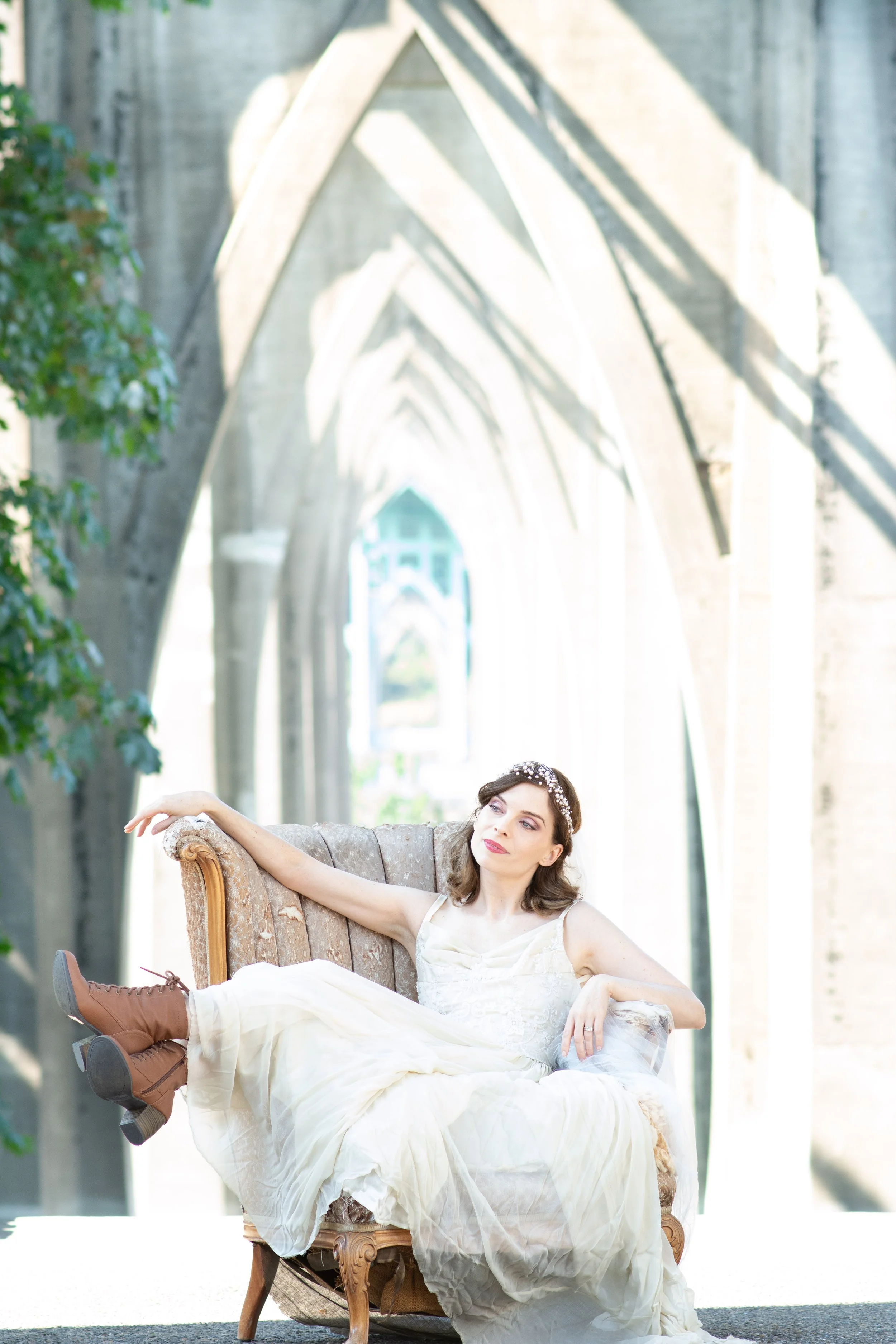 Tacoma wedding photographer bridal portrait soft natural light romantic bride sitting under light filled arches Seattle wedding photographer Lisa LeVan Photography
