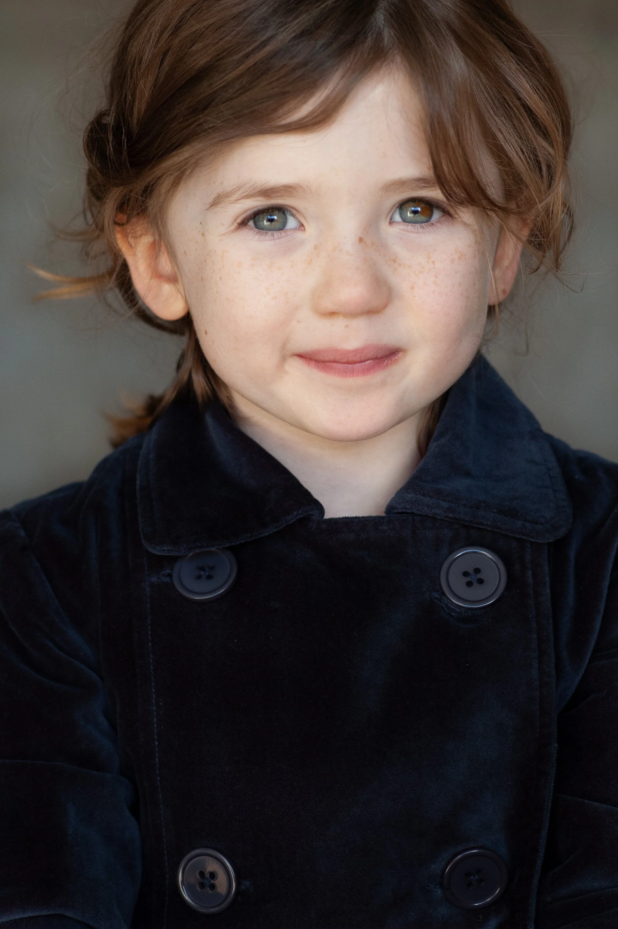 Candid child portrait with gentle smile and natural lighting in Tacoma Washington by Lisa LeVan Photography
