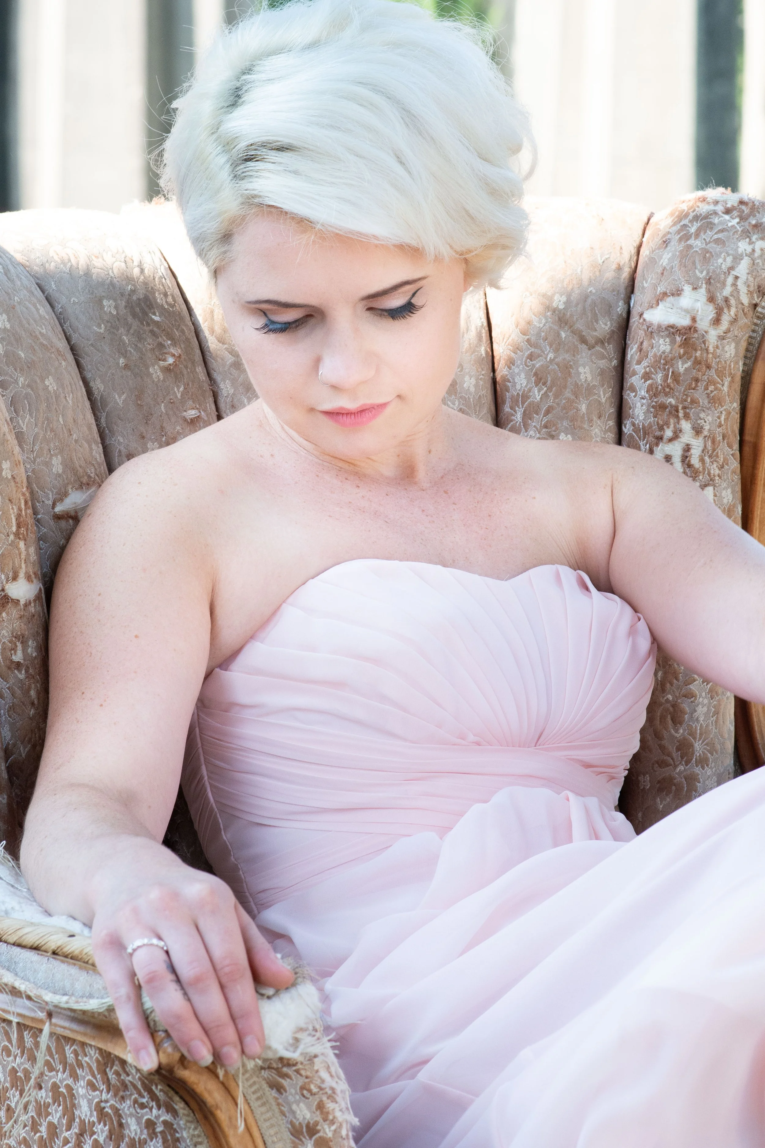 Seattle wedding photographer bride close up in soft blush gown seated looking down with soft makeup portrait Tacoma wedding photographer