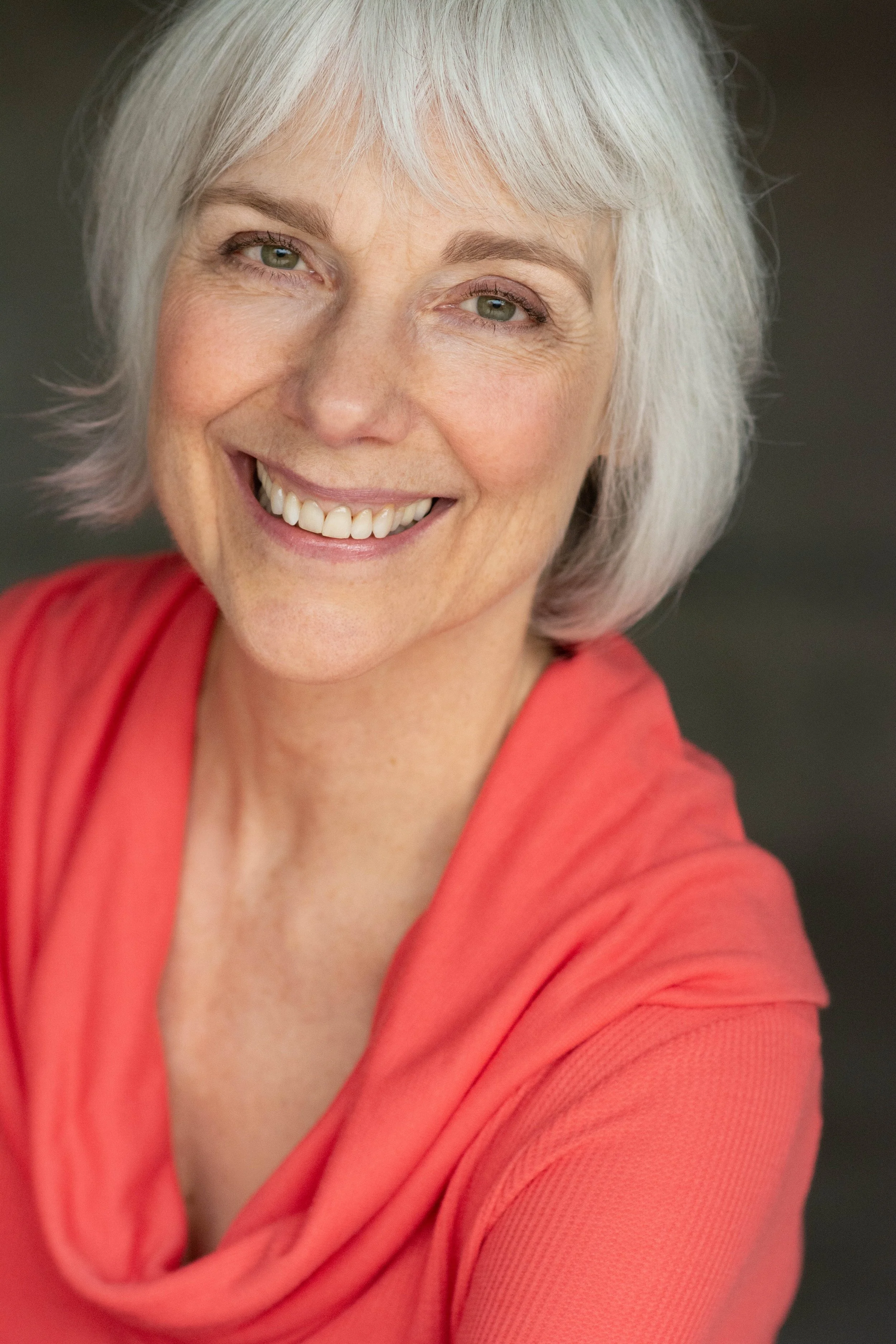 Warm and natural headshot of older woman smiling in Seattle Washington portrait photography