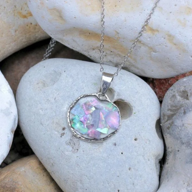 Abalone Shell Pendant Necklace. 

Luminous and eye-catching, this handmade resin necklace features natural abalone shell fragments preserved in clear resin, showcasing iridescent tones of pink, green and soft violet. The shifting colours catch the li