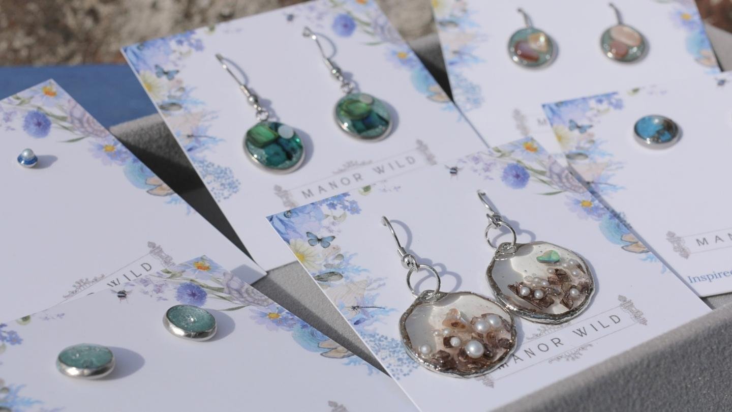 Jewelry display with earrings and pins on floral cards