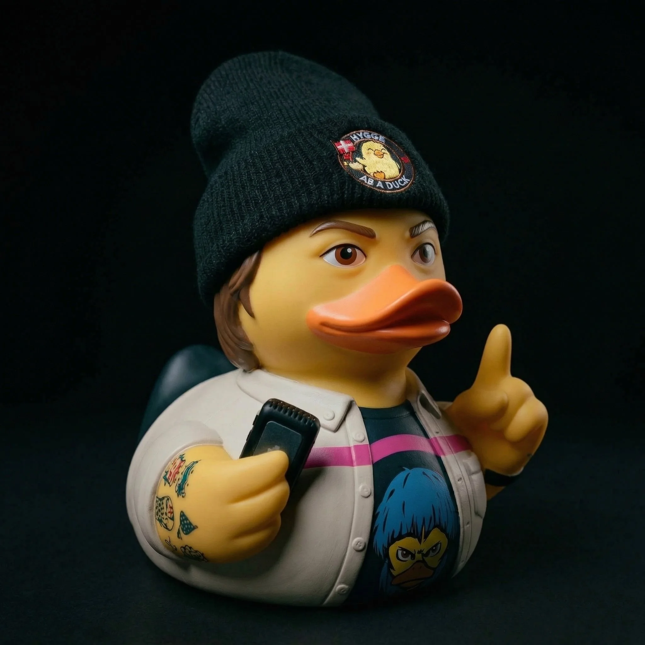 A rubber duck with a black beanie hat and tattoos