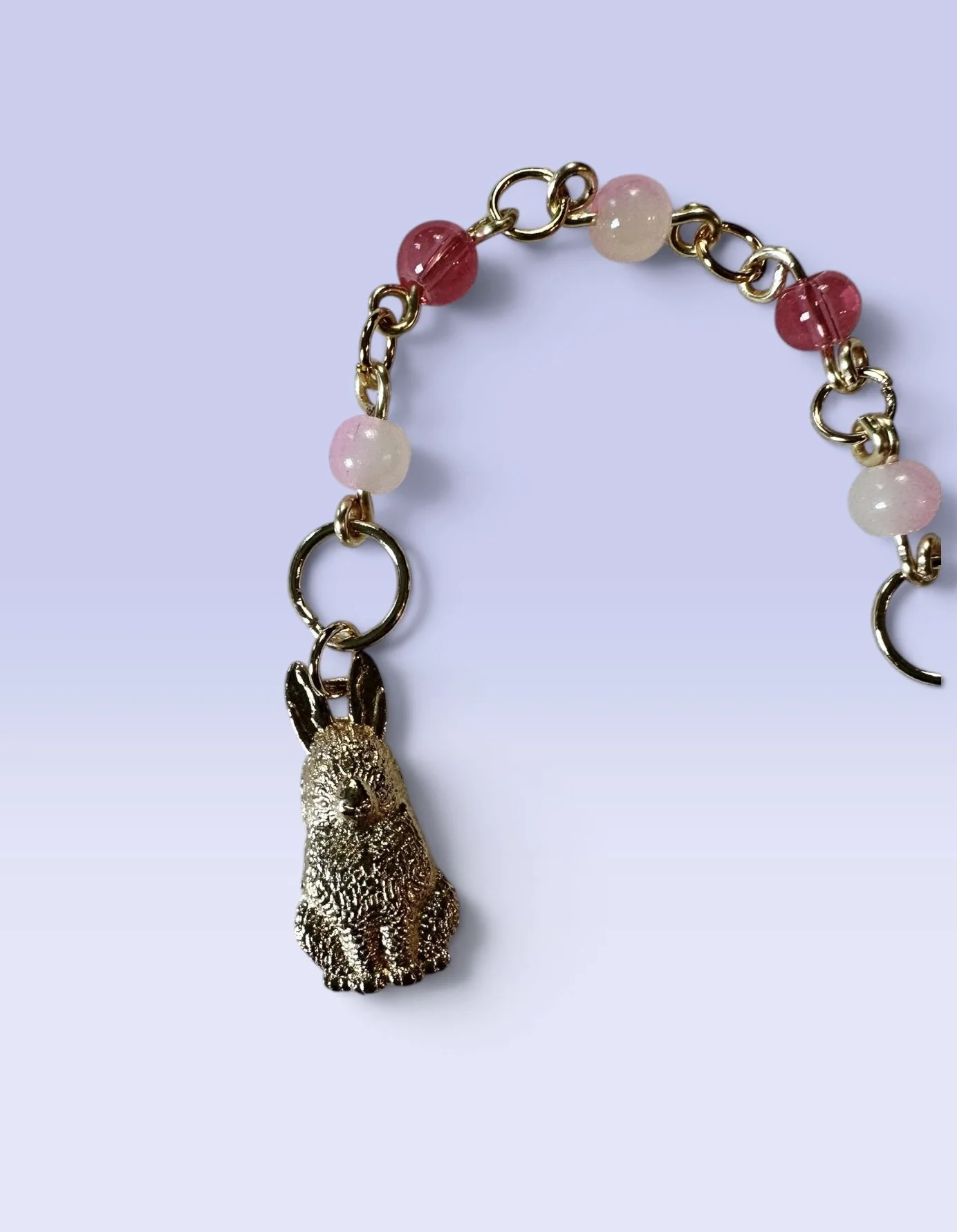 Handmade children's charm featuring a gold rabbit charm with pink and rose glass beads — part of the Peony collection. Hypoallergenic clasp hardware.