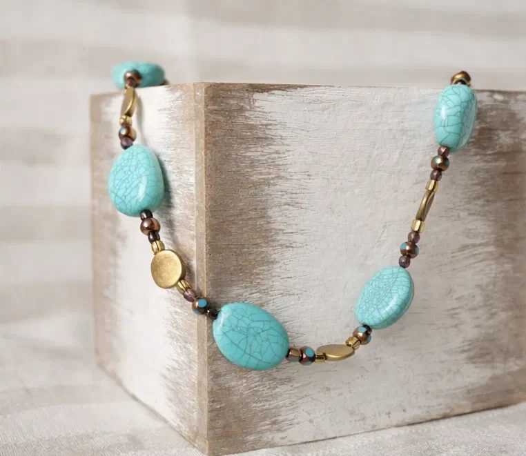 Handmade beaded necklace featuring turquoise stone beads and gold accents — part of the Still Water collection. Hypoallergenic hardware, hand-strung one at a time.
