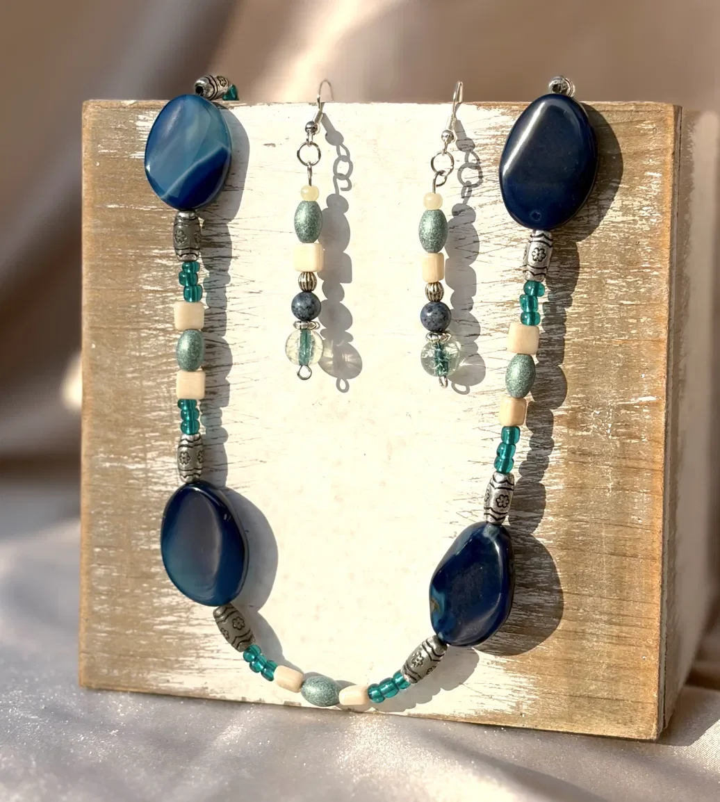 Handmade artisan jewelry set featuring deep blue stone beads, silver accents, and glass detailing — part of the Deep Blue Lake collection. Hypoallergenic hardware, hand-strung and paired to match.