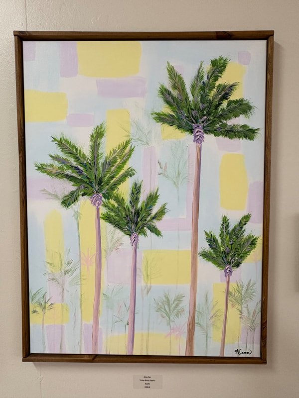 Painting of four tall palm trees with green fronds on a pastel-colored background of pink, yellow, and light blue, framed in wood.